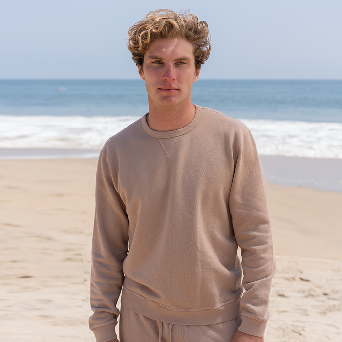 A man wearing a brown sweatshirt